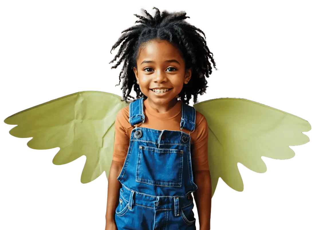Smiling girl in denim overalls wearing paper wings