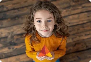 Happy girl holding a paper plane