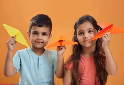 kids playing with paper plane
