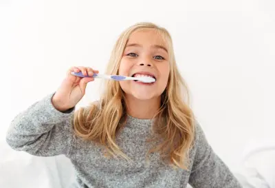 cute girl brushing her teeth